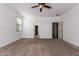 Spacious bedroom with neutral tones, carpet flooring and ceiling fan for comfortable living at 3127 W Apollo Rd, Phoenix, AZ 85041