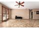 Open-concept living room featuring tile floors, neutral walls and a ceiling fan at 3127 W Apollo Rd, Phoenix, AZ 85041