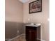 Cozy powder room featuring tile floors, classic vanity with framed art and a sink at 3127 W Apollo Rd, Phoenix, AZ 85041