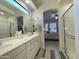 Bathroom featuring double sinks, a large mirror, and a view into the primary bedroom at 3131 E Legacy Dr # 2105, Phoenix, AZ 85042