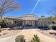 Community clubhouse entrance, framed by palm trees and desert plants with a central walkway to the entryway at 3131 E Legacy Dr # 2105, Phoenix, AZ 85042