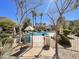 Community pool area with lounge chairs, umbrellas, and a landscaped surround at 3131 E Legacy Dr # 2105, Phoenix, AZ 85042