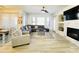 Bright living room with a corner fireplace, neutral color palette, and wood-look tile flooring at 3131 E Legacy Dr # 2105, Phoenix, AZ 85042