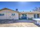 View of backyard with grass, rock bed, and covered patio at 3210 W Belmont Ave, Phoenix, AZ 85051