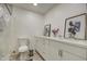 Bright bathroom featuring a modern white vanity, decor, toilet, and a tiled walk-in shower at 3210 W Belmont Ave, Phoenix, AZ 85051