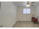 Neutral bedroom showcasing wood-look floors, a ceiling fan, and a red wagon at 3210 W Belmont Ave, Phoenix, AZ 85051