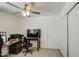 Cozy room showcases wood-look floors, ceiling fan, closet, and a desk with a computer at 3210 W Belmont Ave, Phoenix, AZ 85051