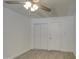 Bright bedroom with wood-look floors, neutral walls, a ceiling fan, and a closet at 3210 W Belmont Ave, Phoenix, AZ 85051