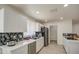 Bright kitchen features stainless steel appliances, shaker cabinets and a gray backsplash at 3210 W Belmont Ave, Phoenix, AZ 85051