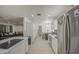 View of the kitchen and dining area with stainless steel appliances and shaker cabinets at 3210 W Belmont Ave, Phoenix, AZ 85051