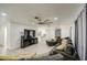 Bright living room featuring tile floors, white walls, and a modern ceiling fan at 3210 W Belmont Ave, Phoenix, AZ 85051