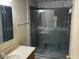 Bathroom shows glass enclosed shower with seat, gray tile, and stylish vanity at 3330 E Main St # 323, Mesa, AZ 85213