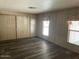 Bedroom showcases neutral walls, hardwood floors, and sizable windows at 3330 E Main St # 323, Mesa, AZ 85213