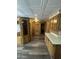 Hallway featuring wood cabinets, paneled walls and textured ceilings at 3330 E Main St # 323, Mesa, AZ 85213