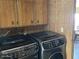 This laundry room features modern appliances and wood cabinets at 3330 E Main St # 323, Mesa, AZ 85213