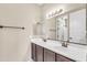 Bathroom boasts dual sinks with dark wood cabinets and a large framed mirror at 3443 S California St, Chandler, AZ 85248