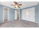 Bedroom features neutral carpet, a ceiling fan, closet with sliding doors, and a window at 3443 S California St, Chandler, AZ 85248