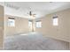 A carpeted bedroom featuring three windows and a ceiling fan, providing a bright and airy feel for relaxation at 3443 S California St, Chandler, AZ 85248