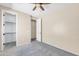 A carpeted bedroom features two doors and a ceiling fan, providing a simple and functional space for rest at 3443 S California St, Chandler, AZ 85248