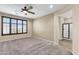 Bright bedroom featuring neutral walls, carpeted floors, and an ensuite bathroom at 3443 S California St, Chandler, AZ 85248