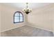 Bright dining room featuring a large window and elegant chandelier at 3443 S California St, Chandler, AZ 85248