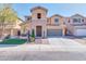 Beautiful two-story home featuring a stone facade, attached two car garage, and well maintained landscaping at 3443 S California St, Chandler, AZ 85248