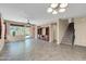 Spacious living room featuring tile flooring, a ceiling fan, and an entertainment center, offering a comfortable gathering space at 3443 S California St, Chandler, AZ 85248