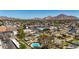 Panoramic aerial showcases houses with pools nestled near picturesque mountain views in a vibrant community at 3707 E Amelia Ave, Phoenix, AZ 85018