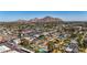 Community aerial view showing pools and homes surrounded by lush greenery in front of a mountain backdrop at 3707 E Amelia Ave, Phoenix, AZ 85018