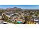 Scenic aerial view captures homes with sparkling pools in a lush community near majestic mountains at 3707 E Amelia Ave, Phoenix, AZ 85018