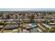 Expansive aerial shot of a neighborhood showcasing homes, palm trees, and a shimmering blue pool at 3707 E Amelia Ave, Phoenix, AZ 85018