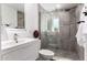 Modern bathroom featuring a glass enclosed shower, white vanity and a sleek mirror at 3707 E Amelia Ave, Phoenix, AZ 85018