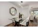 Dining room featuring modern light fixture and a glass table with seating for four people at 3707 E Amelia Ave, Phoenix, AZ 85018