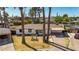 Well-maintained home featuring desert landscaping, a covered carport, and mature palm trees at 3707 E Amelia Ave, Phoenix, AZ 85018