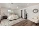 Bright main bedroom featuring modern fan, neutral walls, wood floors, and a decorative rug at 3707 E Amelia Ave, Phoenix, AZ 85018