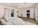 Bright main bedroom featuring modern fan, neutral walls, wood floors, decorative rug and ensuite bathroom access at 3707 E Amelia Ave, Phoenix, AZ 85018