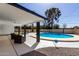 Backyard view with covered patio and pristine pool, perfect for outdoor entertaining and relaxation at 3707 E Amelia Ave, Phoenix, AZ 85018