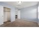 Bedroom with carpet, blue walls, an open closet and an open door at 3891 E Melrose St, Gilbert, AZ 85297