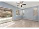 Bright bedroom with neutral tile flooring, modern ceiling fan and backyard access at 3891 E Melrose St, Gilbert, AZ 85297