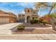 Two-story home featuring a turret entry, a balcony, desert landscaping, and a two-car garage at 3891 E Melrose St, Gilbert, AZ 85297