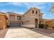 Two-story home featuring a turret entry, a balcony, desert landscaping, and a two-car garage at 3891 E Melrose St, Gilbert, AZ 85297