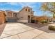 Two-story home featuring a turret entry, a balcony, desert landscaping, and a two-car garage at 3891 E Melrose St, Gilbert, AZ 85297