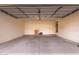 Empty two car garage with concrete floor and a light at 3891 E Melrose St, Gilbert, AZ 85297