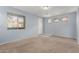 Spacious, light-blue living room with carpeted floors and a large window at 3891 E Melrose St, Gilbert, AZ 85297