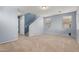 Spacious, light-blue living room with carpeted floors and large windows at 3891 E Melrose St, Gilbert, AZ 85297