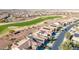 Aerial view of community homes adjacent to a golf course, many featuring solar panels at 3942 N San Marin Dr, Florence, AZ 85132