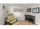 Relaxing bedroom featuring a massage chair, side table, artwork, and black digital piano with wood floor at 3942 N San Marin Dr, Florence, AZ 85132