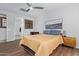 Well-lit bedroom with hardwood floors, stylish furniture, and ample natural light through shuttered windows at 3942 N San Marin Dr, Florence, AZ 85132