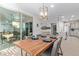 Bright dining room boasts a wood table, stylish chandelier, and sliding glass doors to the outdoor space at 3942 N San Marin Dr, Florence, AZ 85132