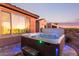 Inviting backyard hot tub with blue accent lighting and views of the evening sky at 3942 N San Marin Dr, Florence, AZ 85132